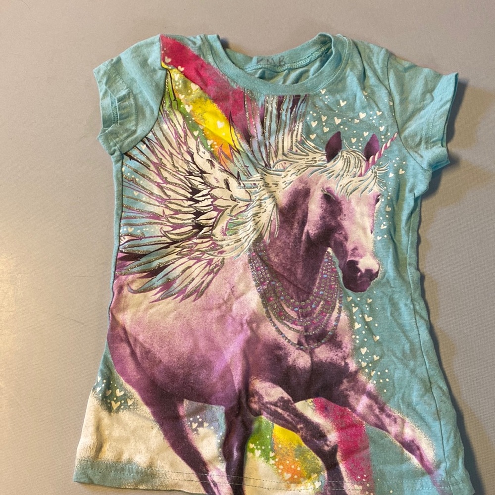 A sparkly unicorn with wings glitter and rainbows